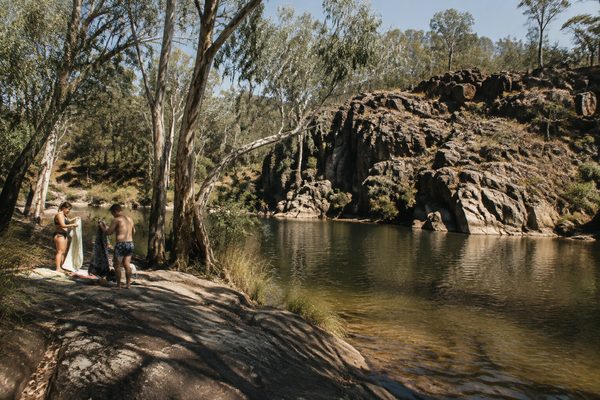 A rocky swimming hole among gum trees