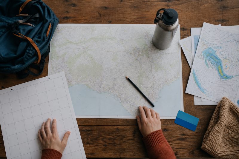 Weekend planning materials arranged across a timber table